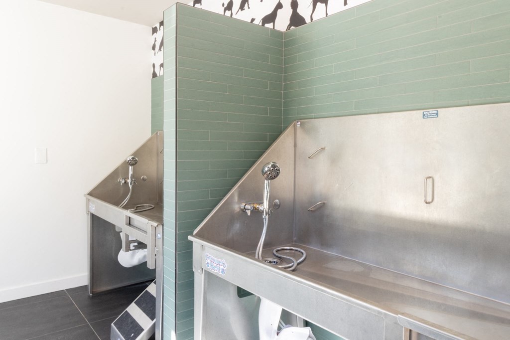 a stainless steel kitchen with two stainless steel sinks and a large stainless steel counter top at The Wren Apartments, Georgia, 30043