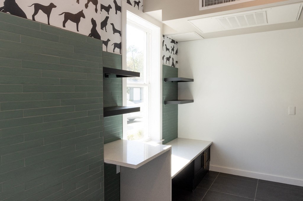 a small kitchen with green tiles and a window at The Wren Apartments, Lawrenceville, Georgia