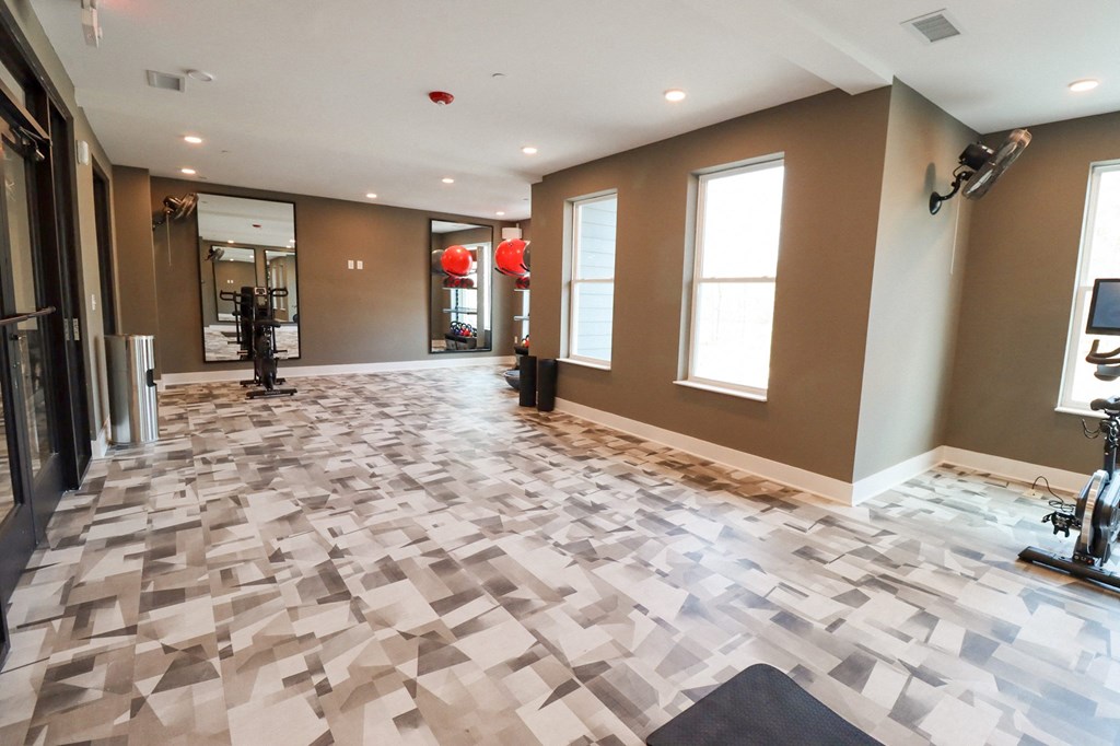 The Wren Fitness Studio yoga room with exercise bike and large mirrors located in Lawrenceville,GA