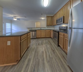 Kitchen with wood style flooring at The Crest at Sugarloaf, Lawrenceville, 30044 - Photo Gallery 17
