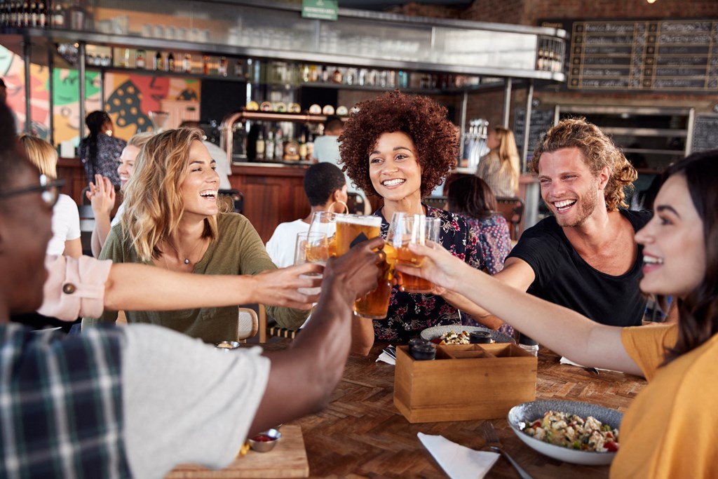 a group of people sitting around a table drinking beer at The Crest at South Point, McDonough Georgia