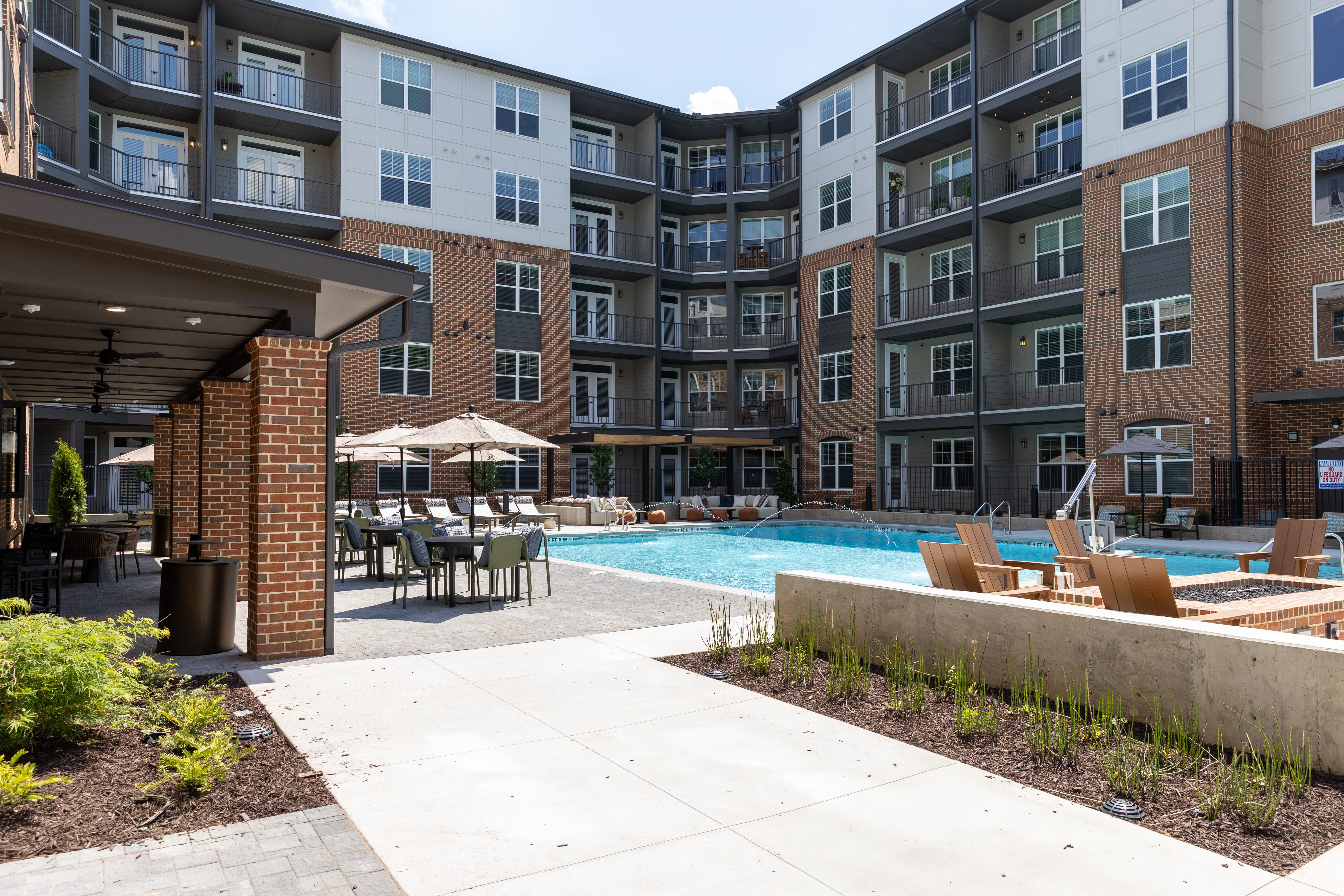 A large apartment complex with a pool and patio area.