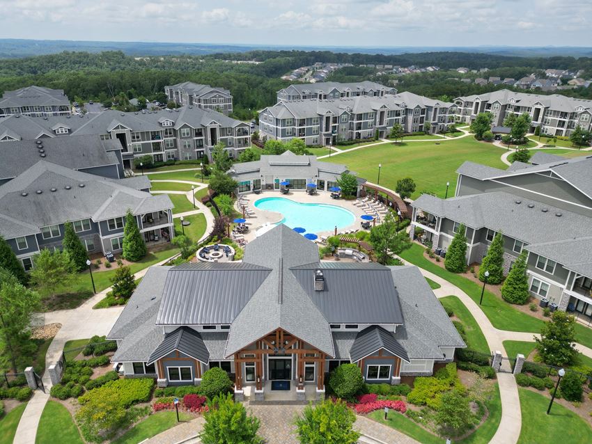 an aerial view of a large complex with a swimming pool and golf course - Photo Gallery 1