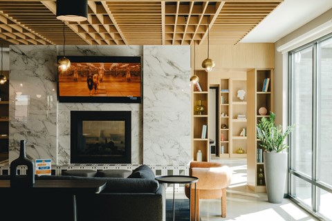 a living room with a fireplace and a large window