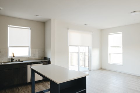 an empty kitchen with a table and a sink