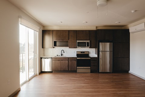 a kitchen with wooden cabinets and stainless steel appliances