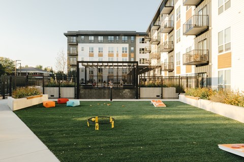 an apartment yard with a seesaw in front of an apartment building