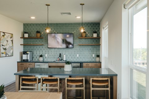 a kitchen with a blue counter top and a tv on the wall