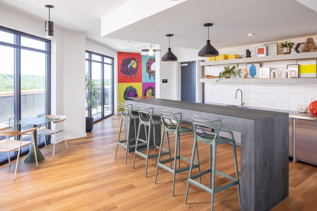 a kitchen with a large counter and stools in front of a kitchen island