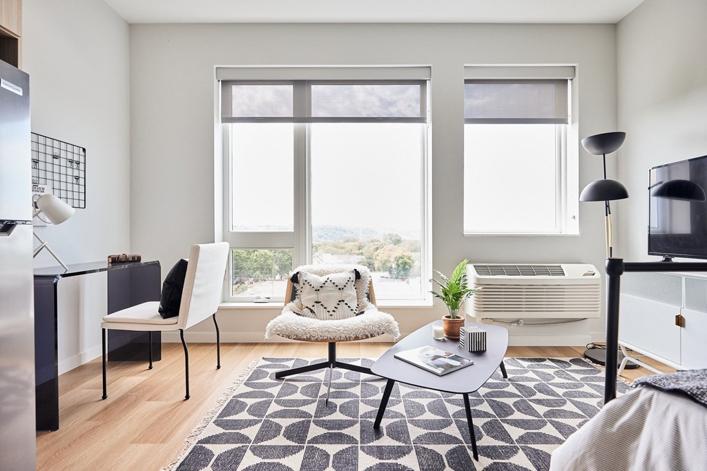 a living room with a chair and a table and a window