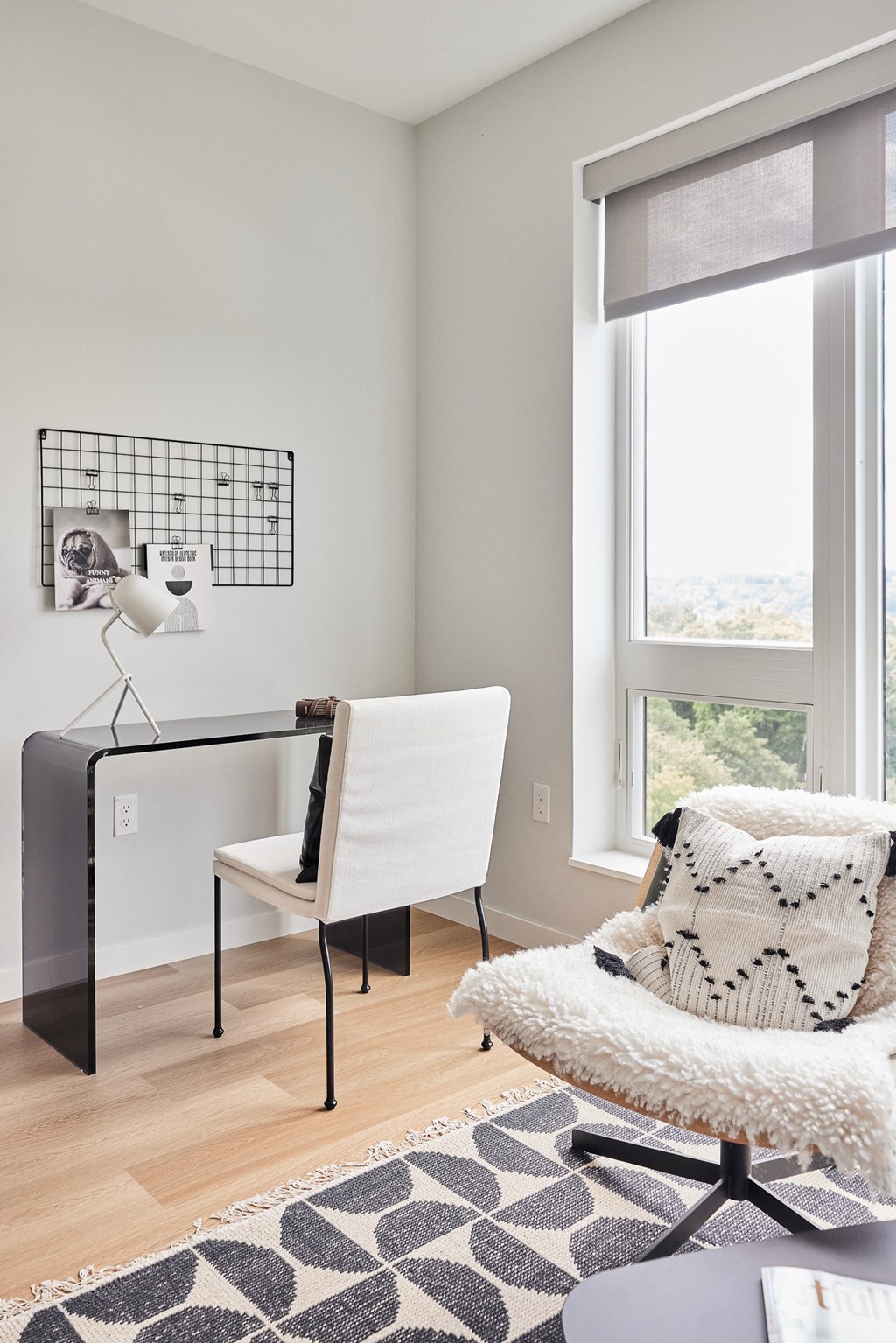 a home office with a chair and a desk and a window