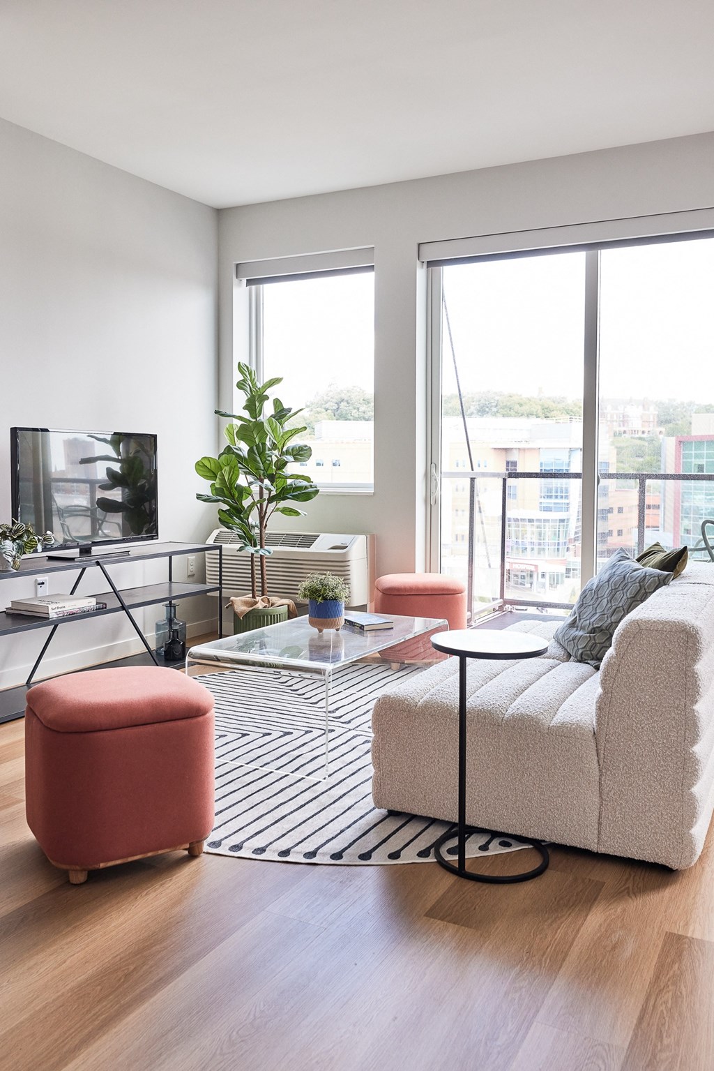 a living room with a couch and a table and a large window