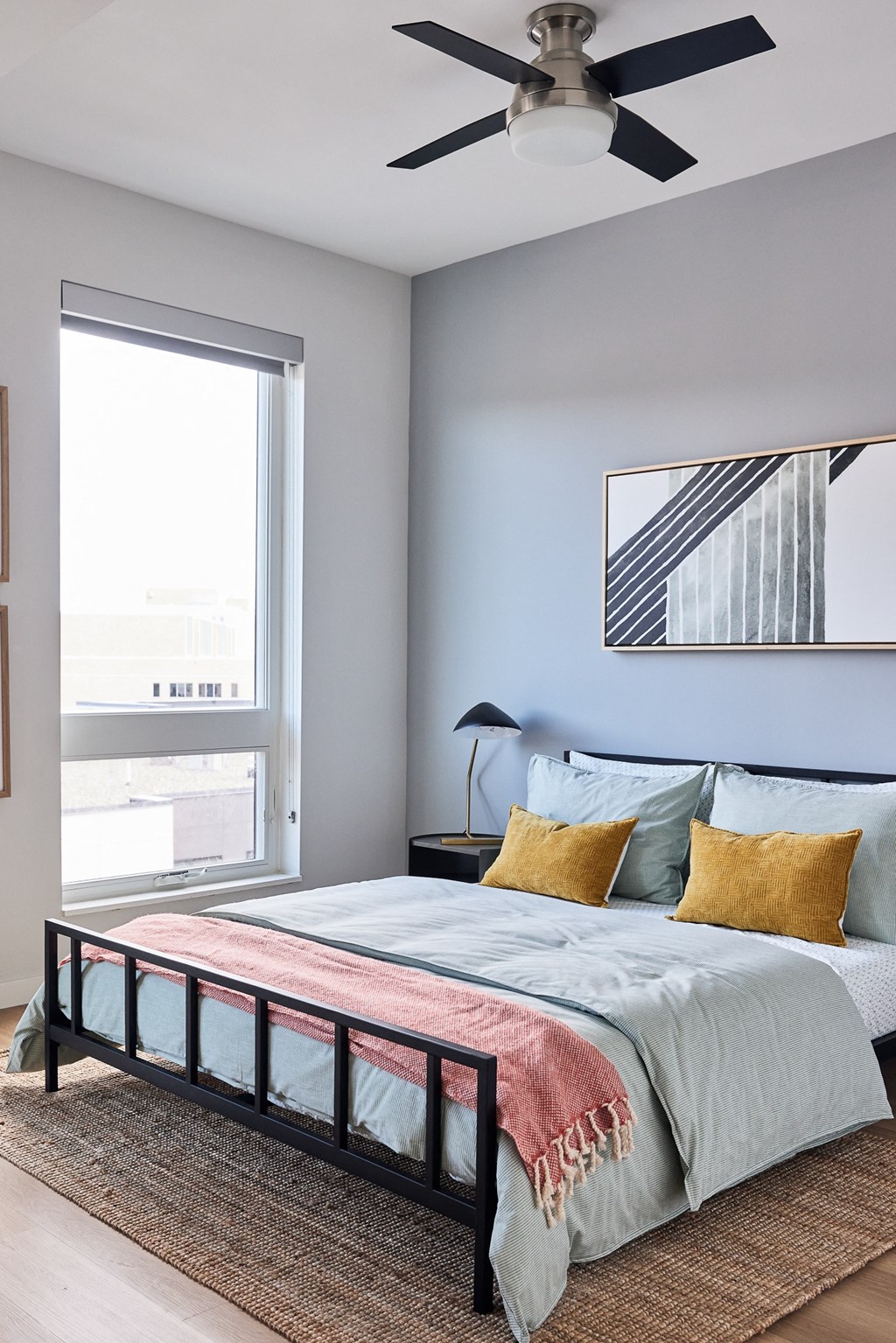 a bedroom with a bed and a ceiling fan