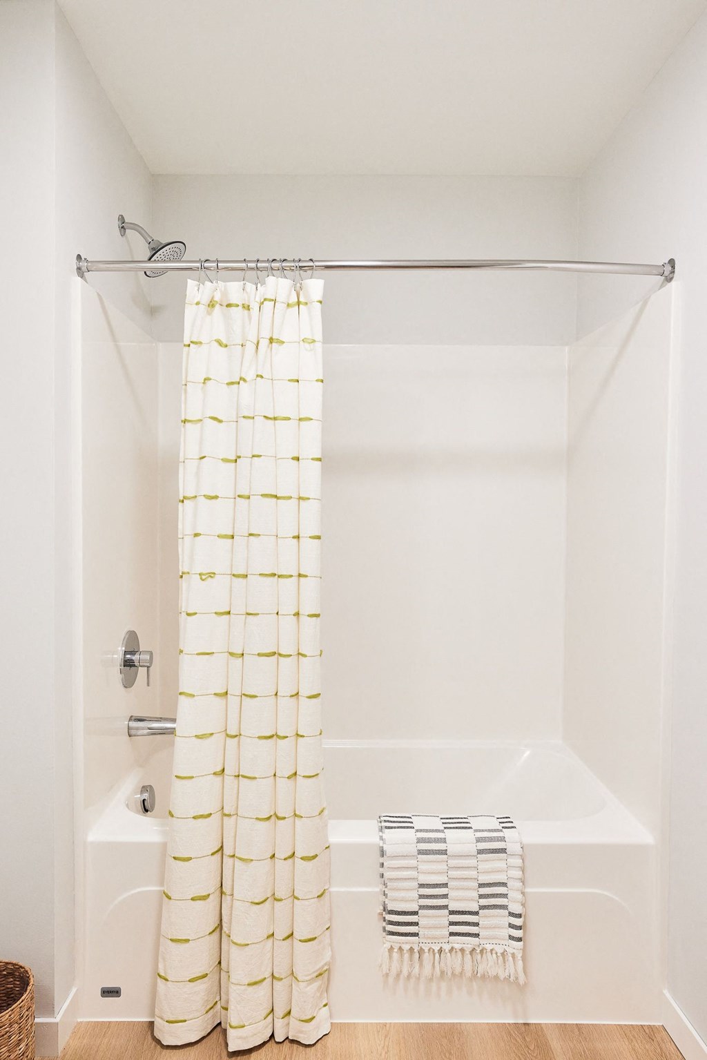 a white bathroom with a shower curtain and a tub