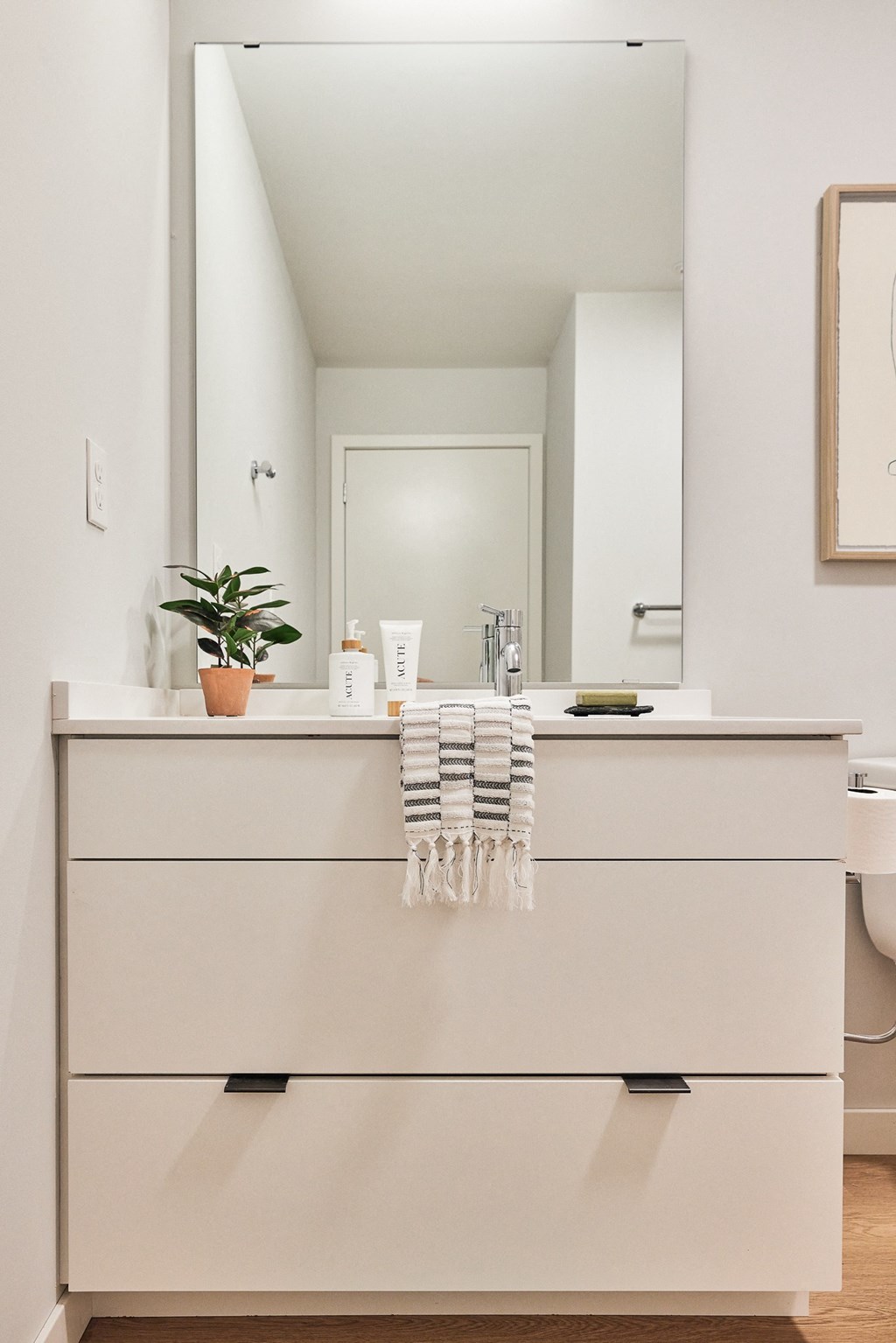 a white bathroom with a sink and a mirror