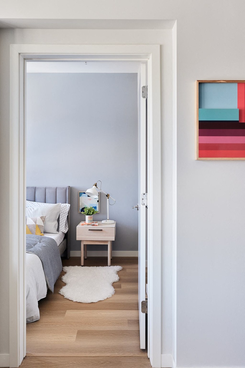 a bedroom with a bed and a night stand