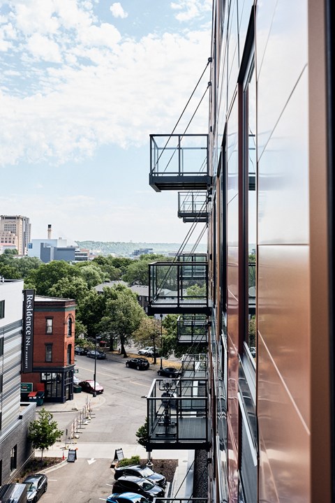 a view of a city street from the balcony of a building
