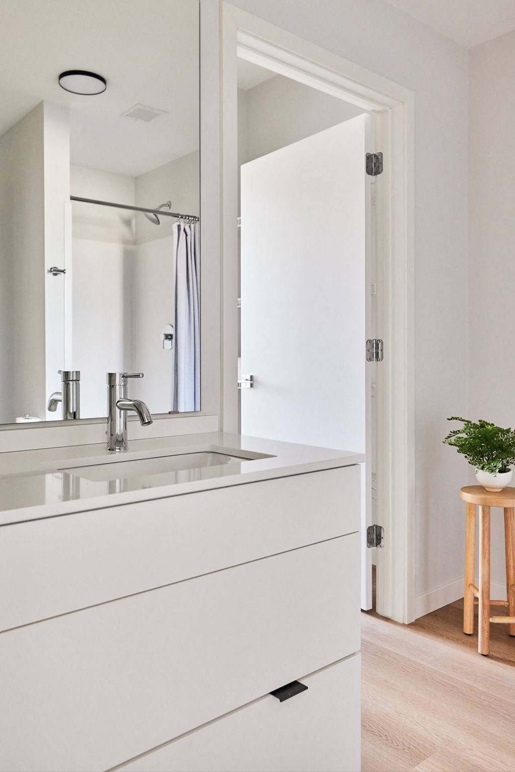 a white bathroom with a sink and a mirror