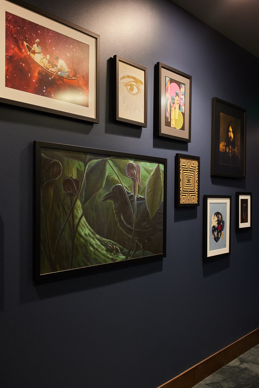 a wall of art on display at a museum