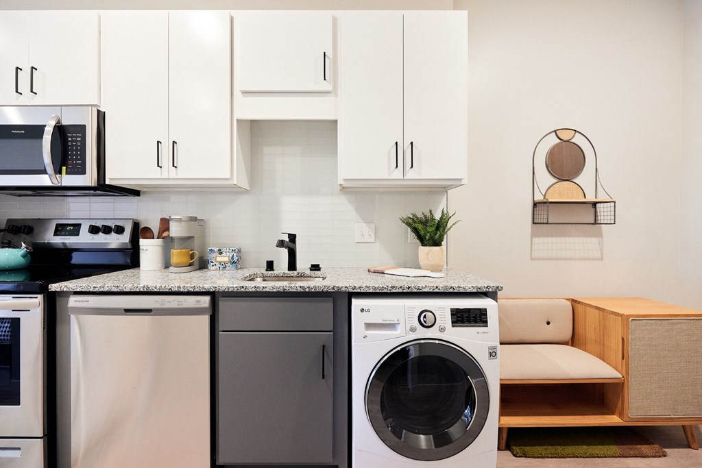 a small kitchen with a washing machine and a dishwasher