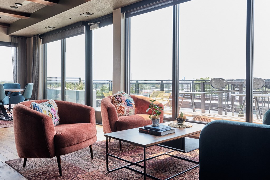a living room with couches and a coffee table with a large window