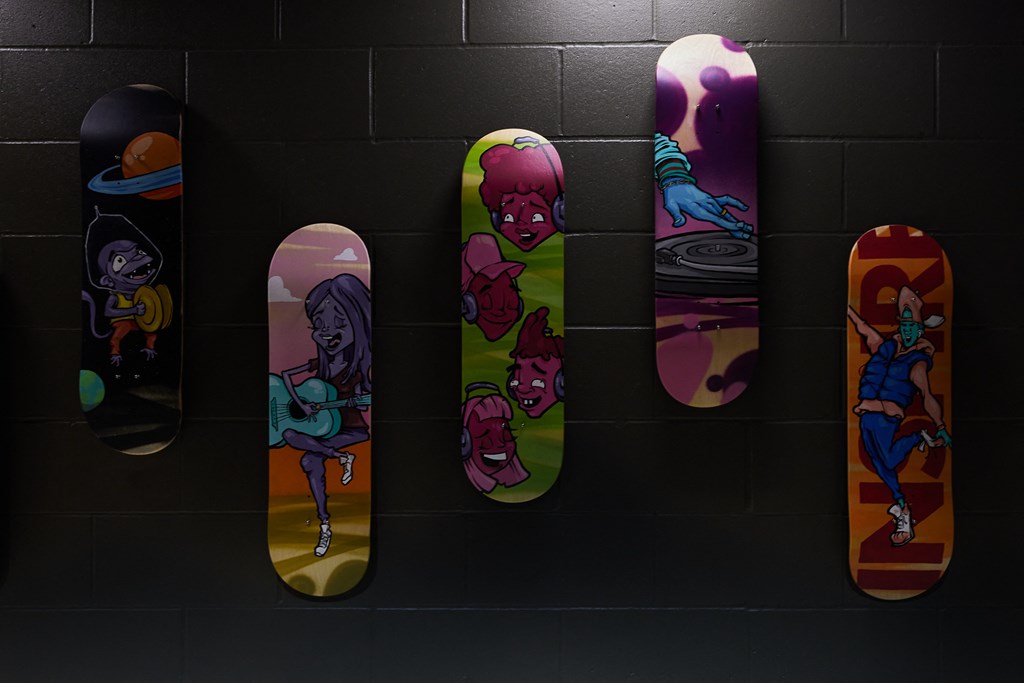 a row of skateboards with anime characters on them