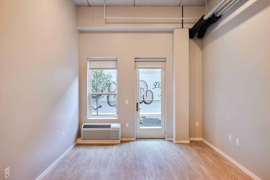 an empty room with a radiator and a glass door