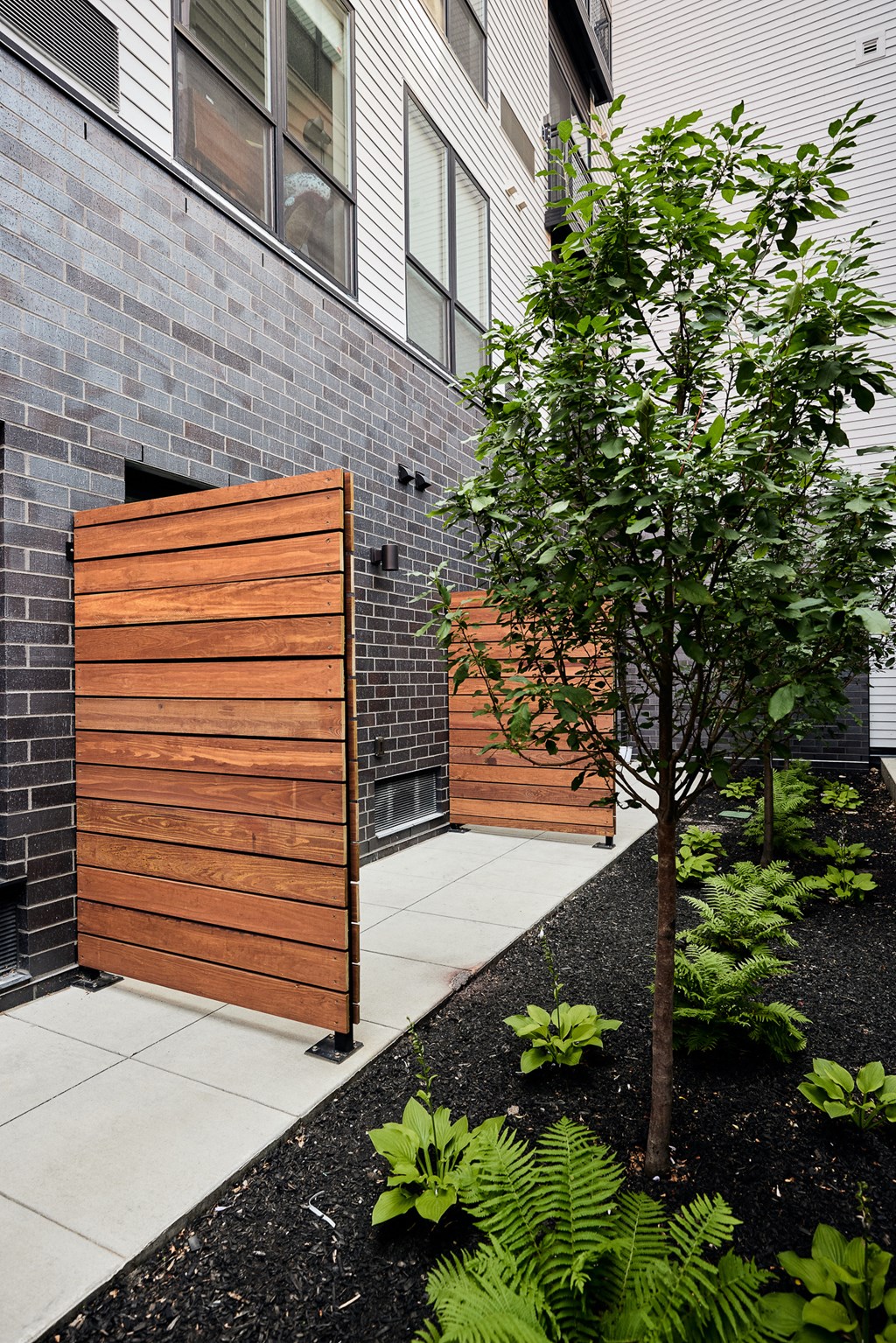 a wooden fence with a tree in front of a building