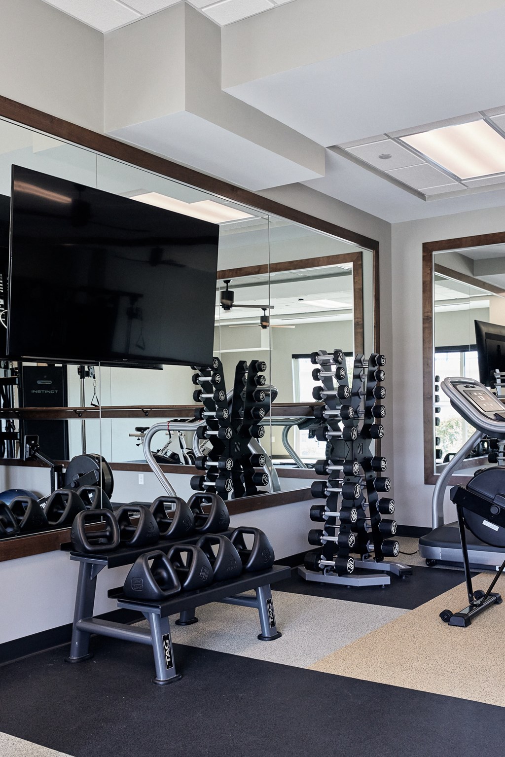 a home gym with weights and a tv