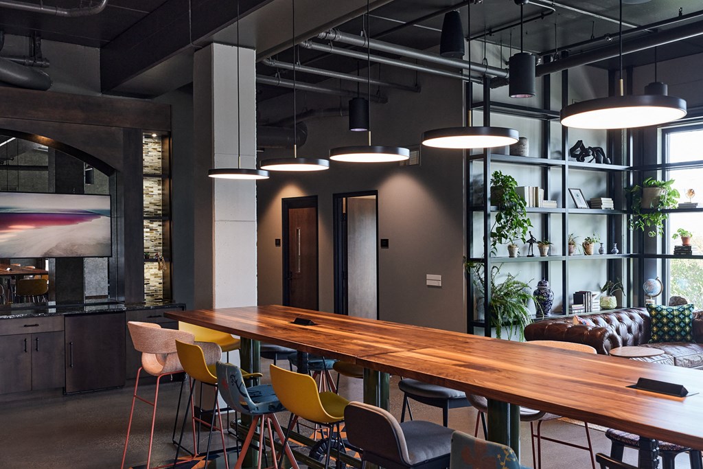 a dining room with a long wooden table and chairs