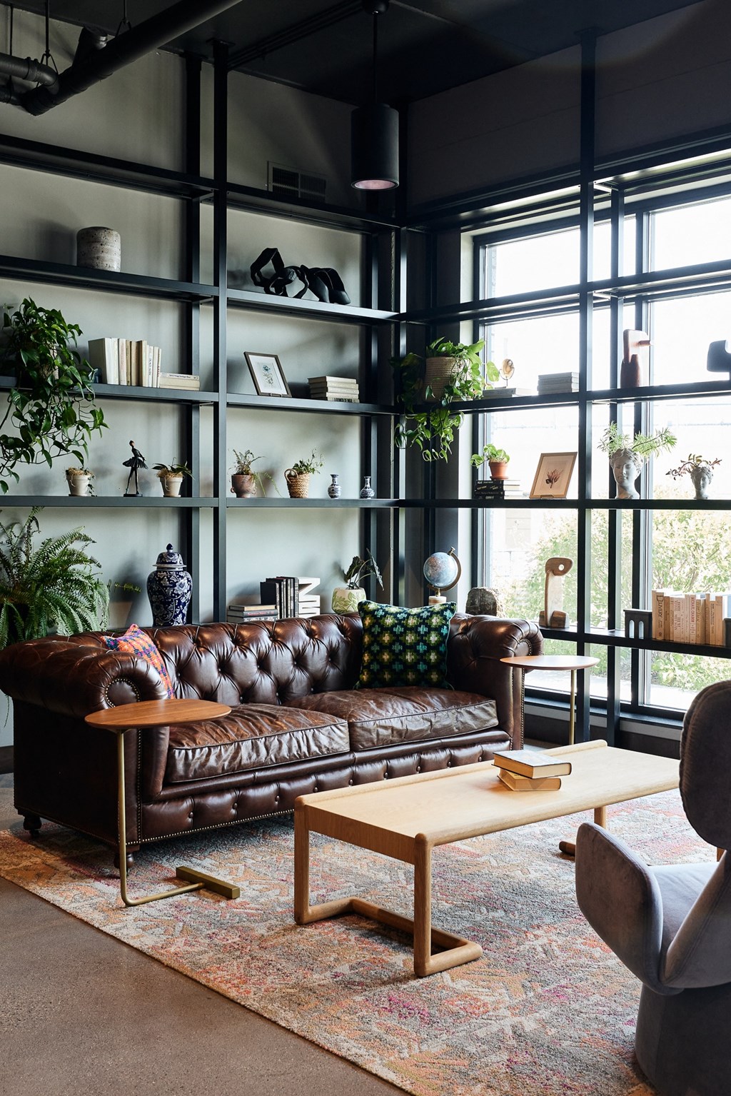 a living room with a brown leather couch and a coffee table