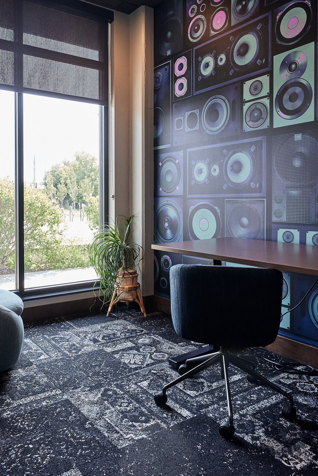 a desk with a chair in a room with a window