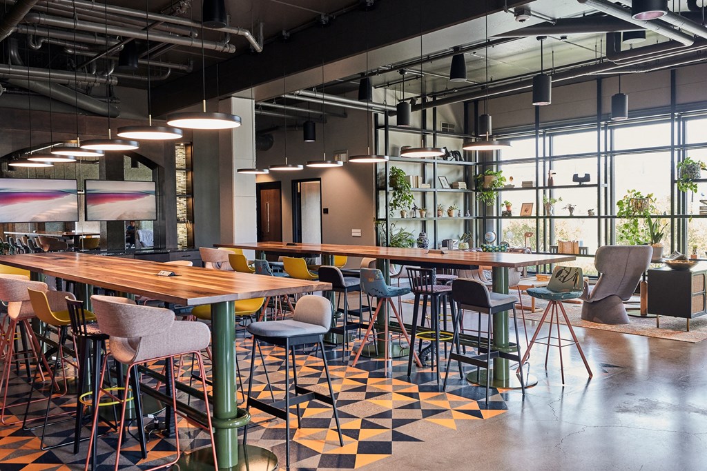 a dining room with tables and chairs and a bar