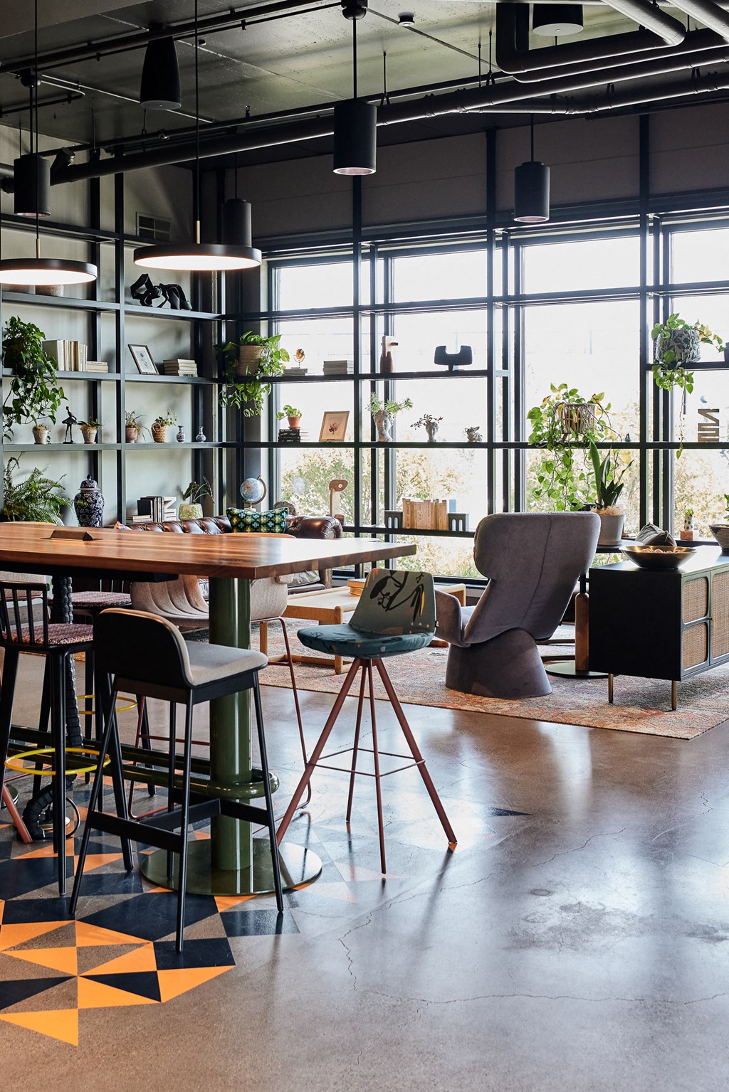 a living room with a table and chairs and a large window