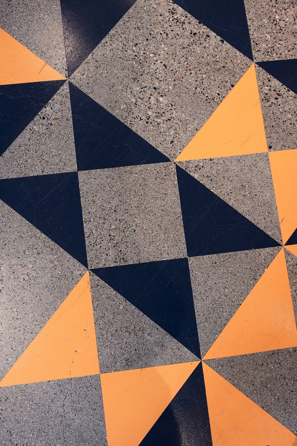 a floor with black and orange triangles on it