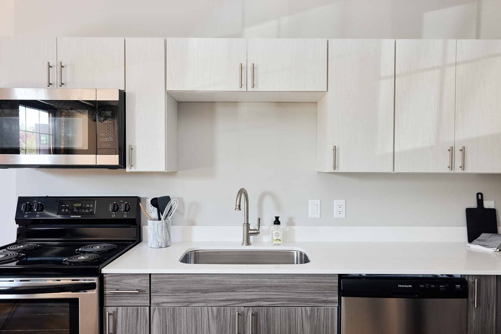 a kitchen with a sink and a stove and a microwave