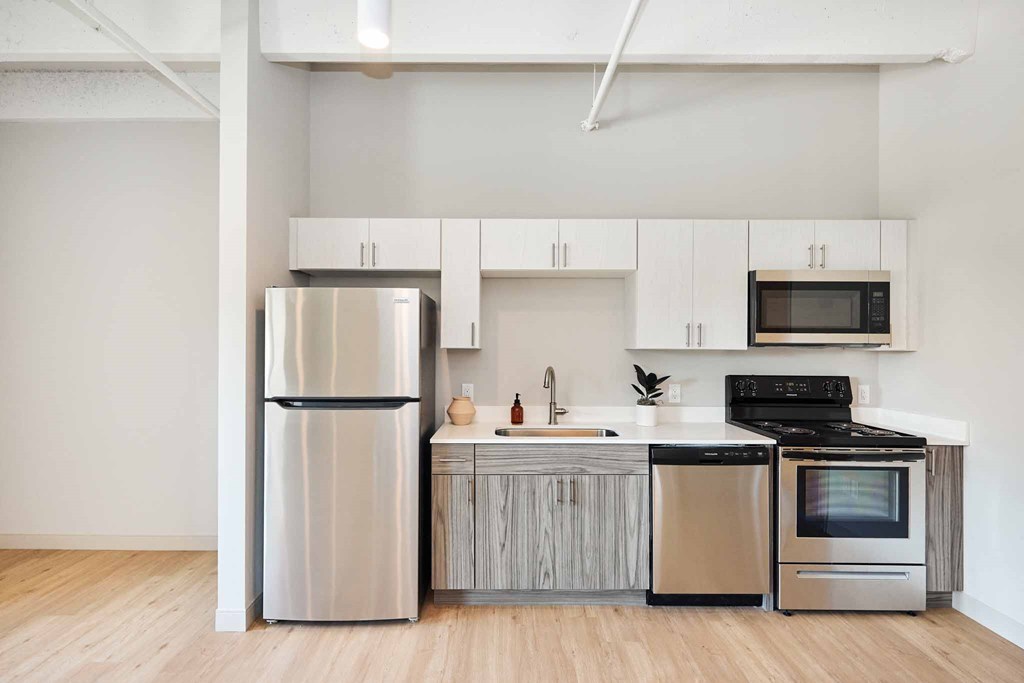 a kitchen with stainless steel appliances and white cabinets