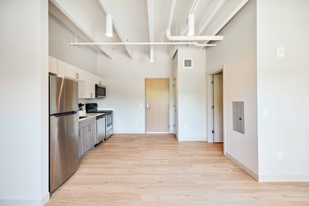a kitchen with stainless steel appliances and a wood floor