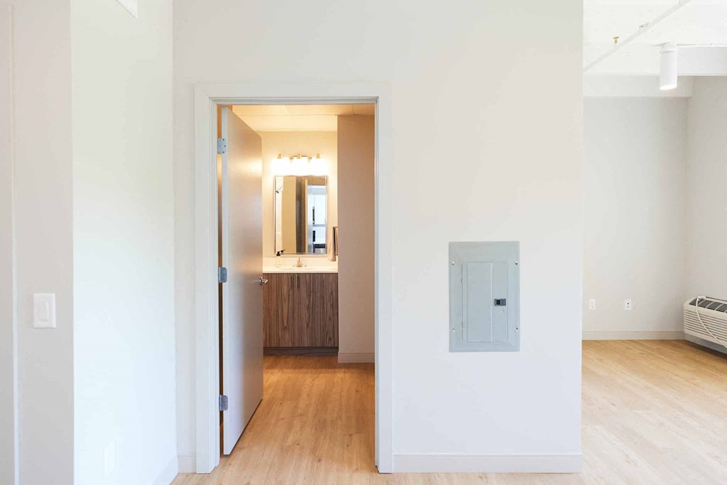 a view of a living room with a door to a bathroom