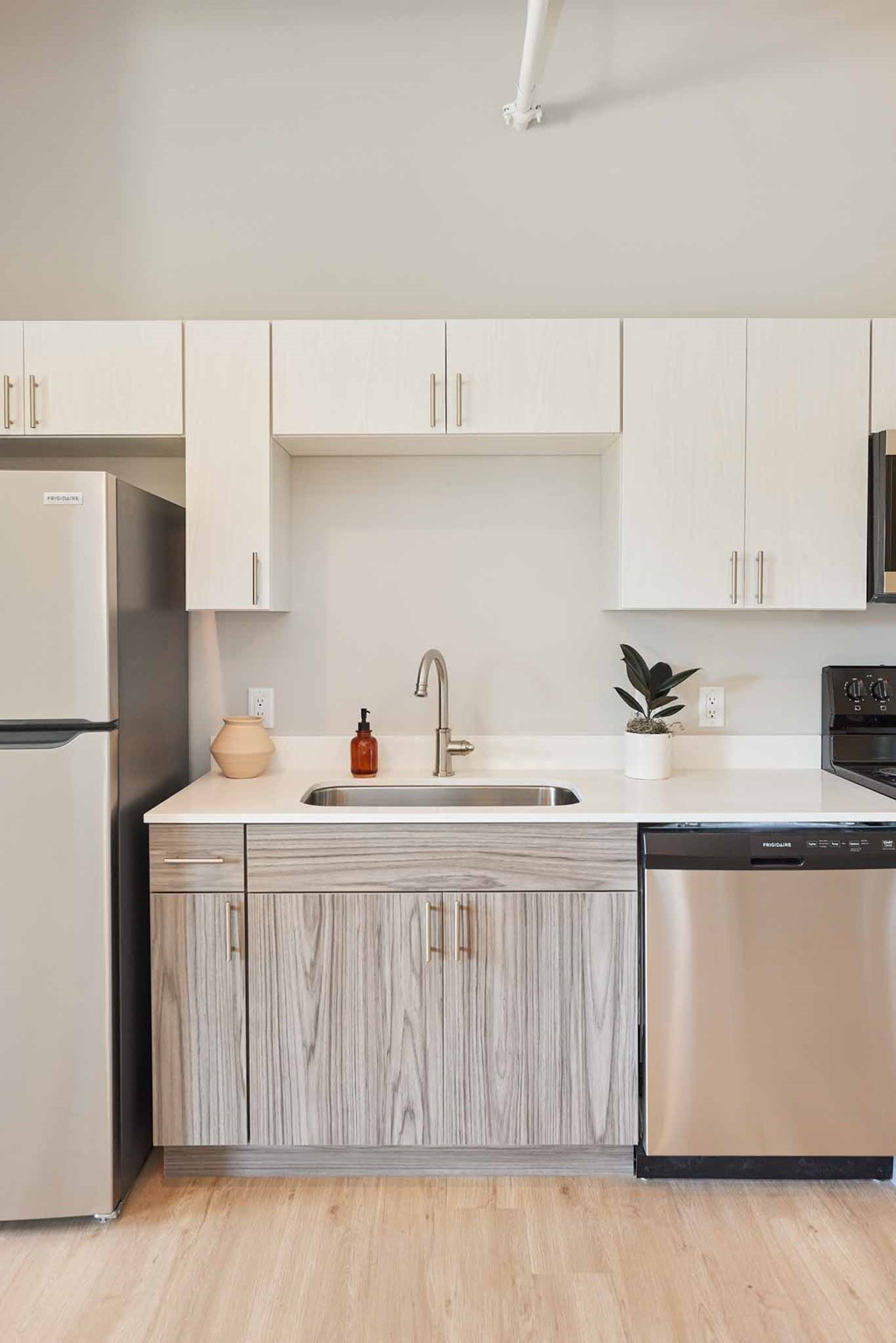 a kitchen with a sink and a refrigerator