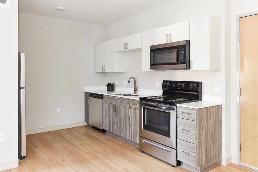 a kitchen with stainless steel appliances and white cabinets