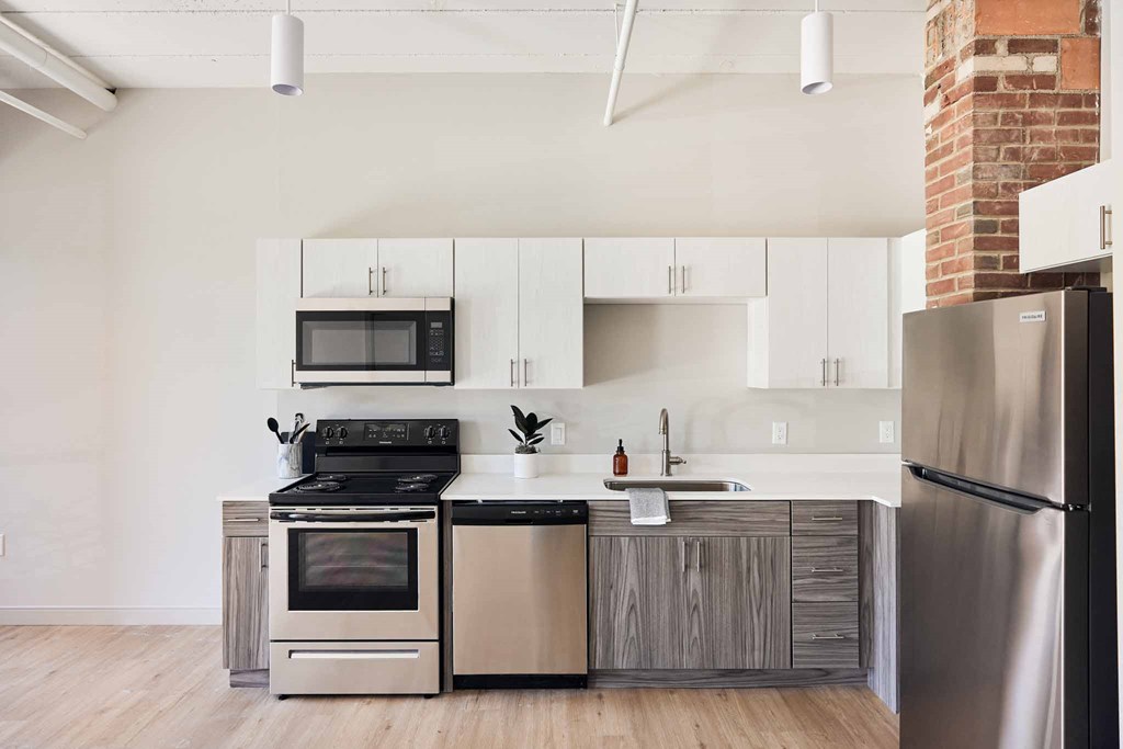 a kitchen with stainless steel appliances and white cabinets