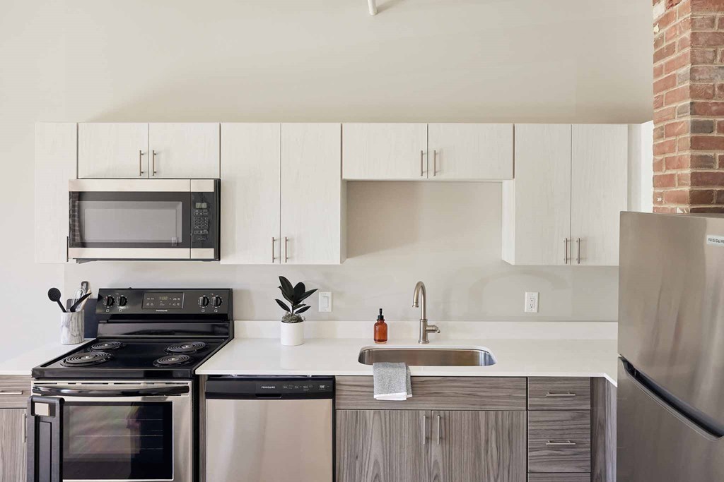 a kitchen with stainless steel appliances and white cabinets