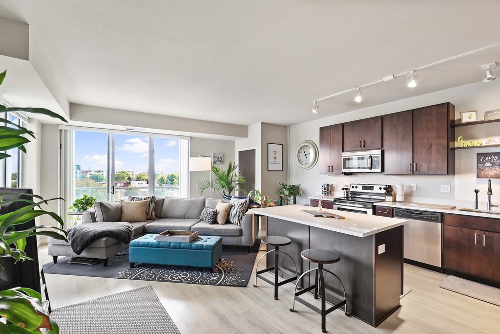 a living room with a kitchen and a couch and a table