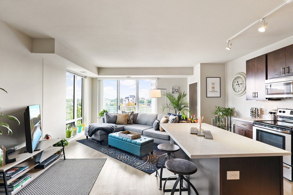 a living room with a kitchen and a couch and a table