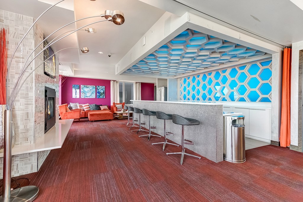 a living room with a bar and a fireplace