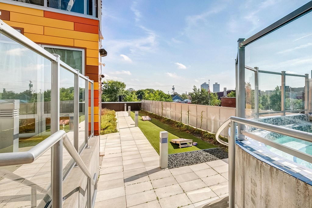 a rooftop terrace with a pool and a view of the city