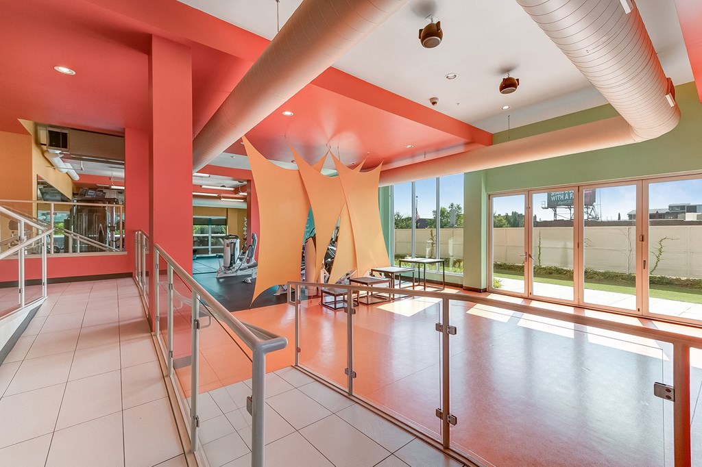a view of the lobby of a building with stairs and glass doors