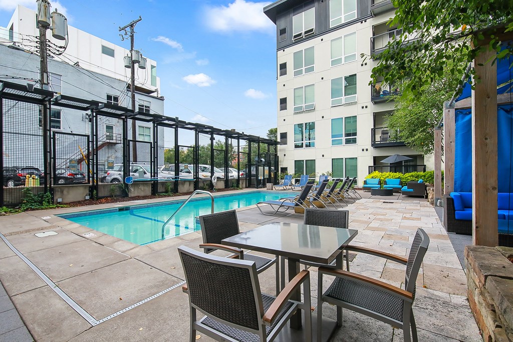our apartments have a pool and a patio with chairs and tables