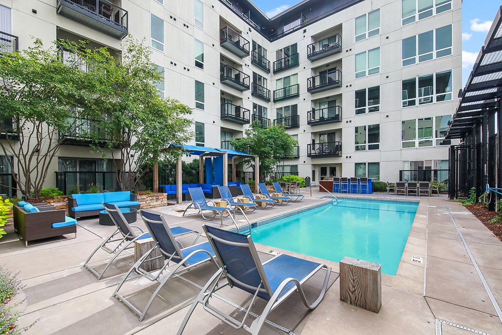 a swimming pool in front of an apartment building